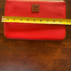 Dooney and Bourke Red Leather Zip Clutch with built in wallet.